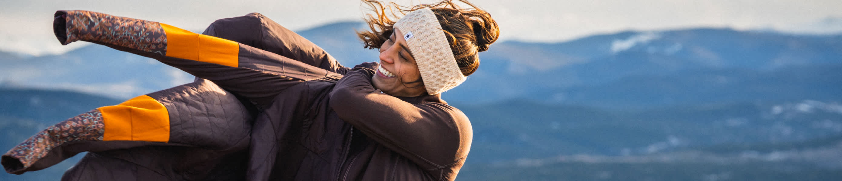 Woman wearing a Smartwool jacket outside