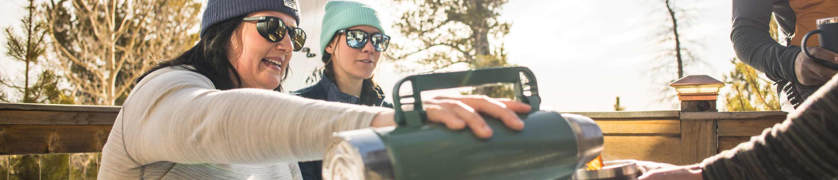Two plus-size women snowshoeing in Smartwool apparel