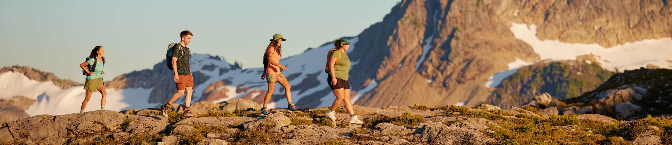 Man and woman hiking in mountains wearing Smartwool apparel