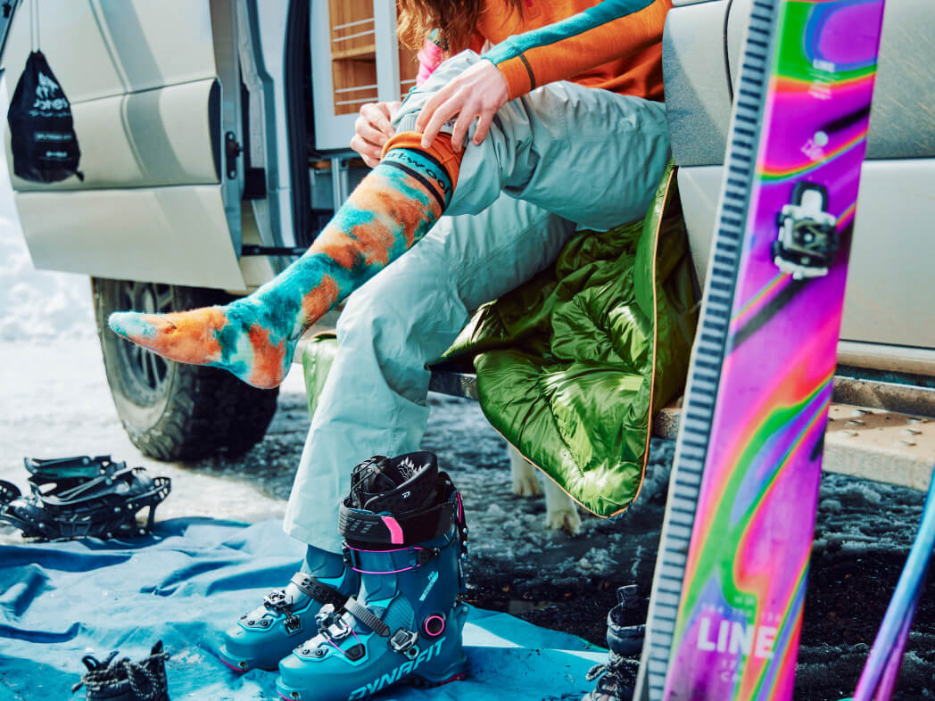 a person pulling up their Smartwool Ski Socks