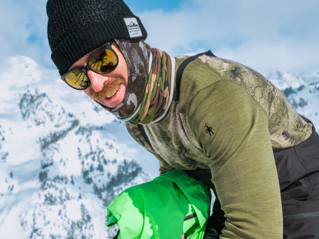 a man wearing Smartwool beanie, gaiter, and base layer