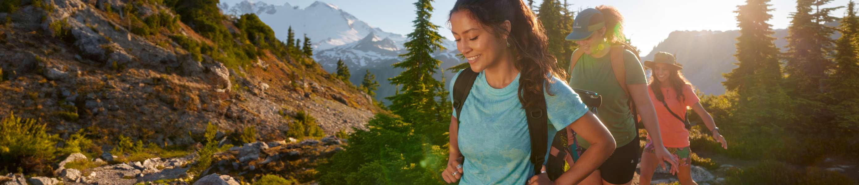two women near log cabin wearing smartwool new apparel