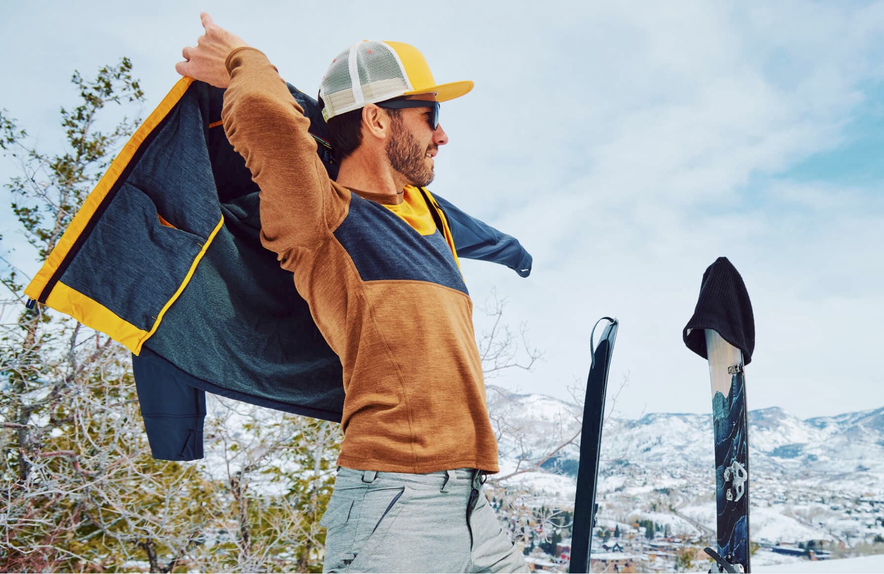 Man putting on a Smartwool Jacket