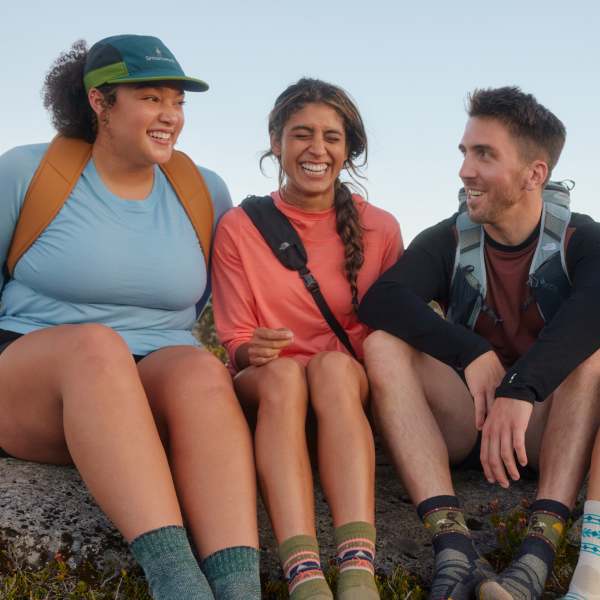 two woman and a man wearing Smartwool base layers